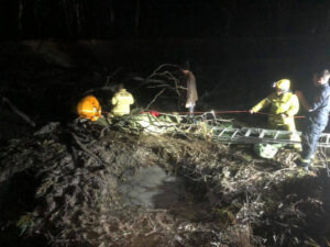 Duck hunter stuck in irrigation channel mud