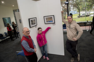 Photographers in the picture with display at Sir John Gorton Library